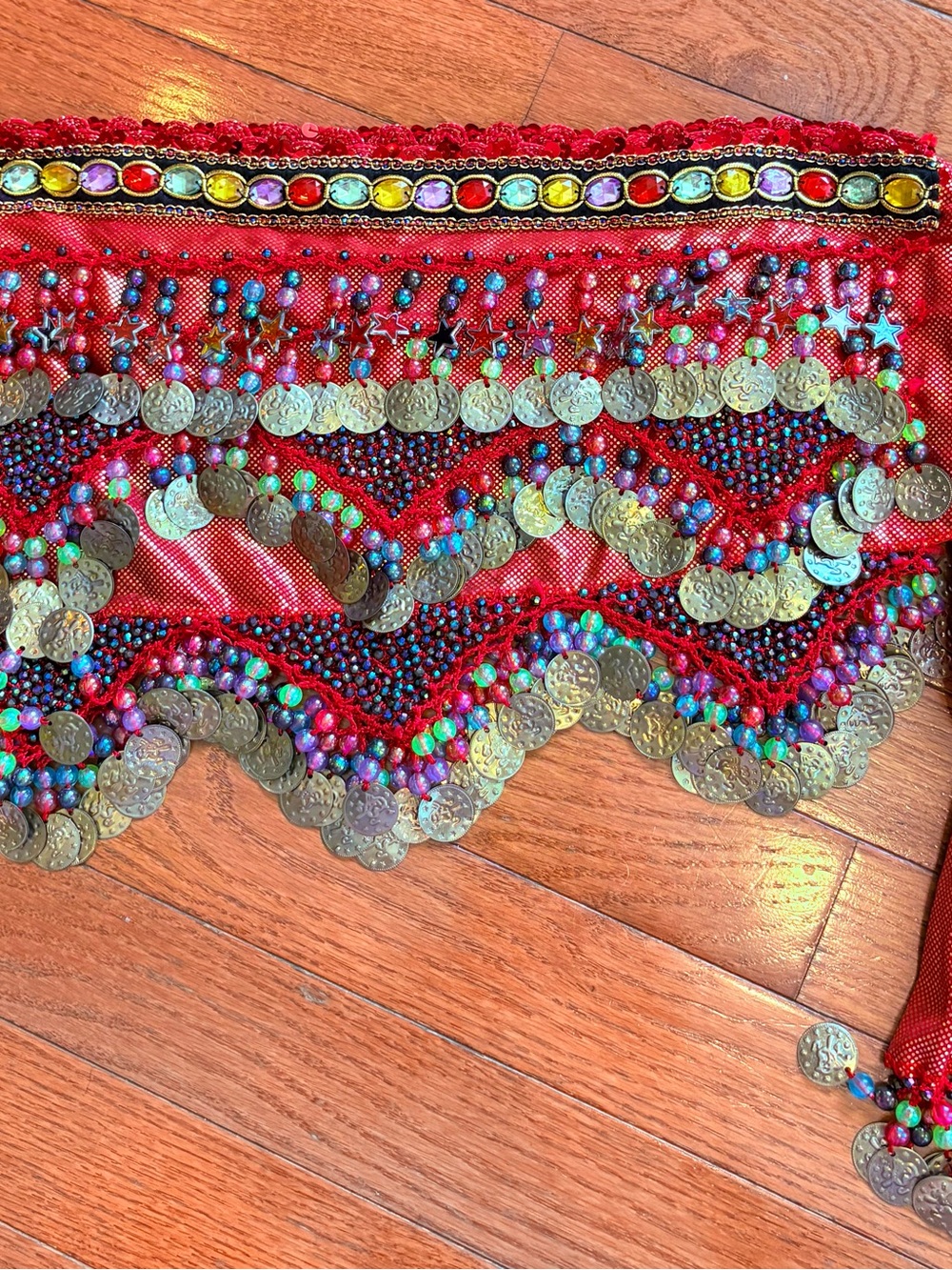 Vintage Egyptian style dance hip scarf on gold and red fabric.